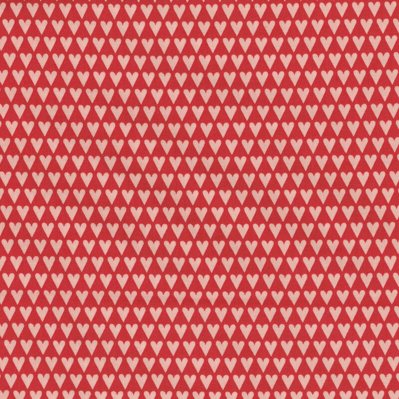 Red fabric with tight organized rows of hearts.