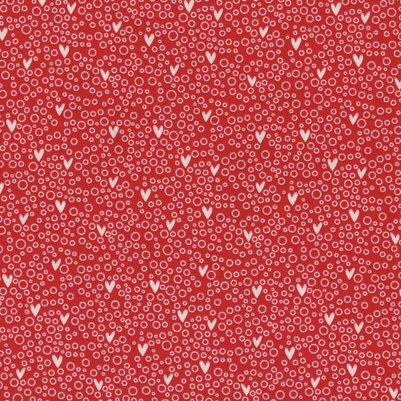 Red fabric with small hearts on a white bubbly background.