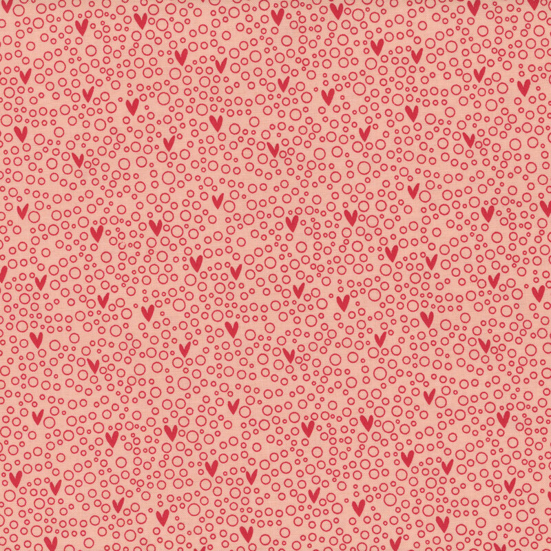 Pink fabric with small hearts on a red bubbly background.