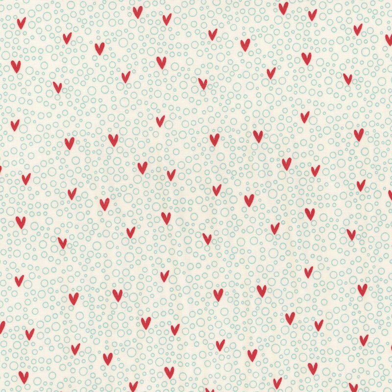 Cream fabric with small hearts on a blue bubbly background.