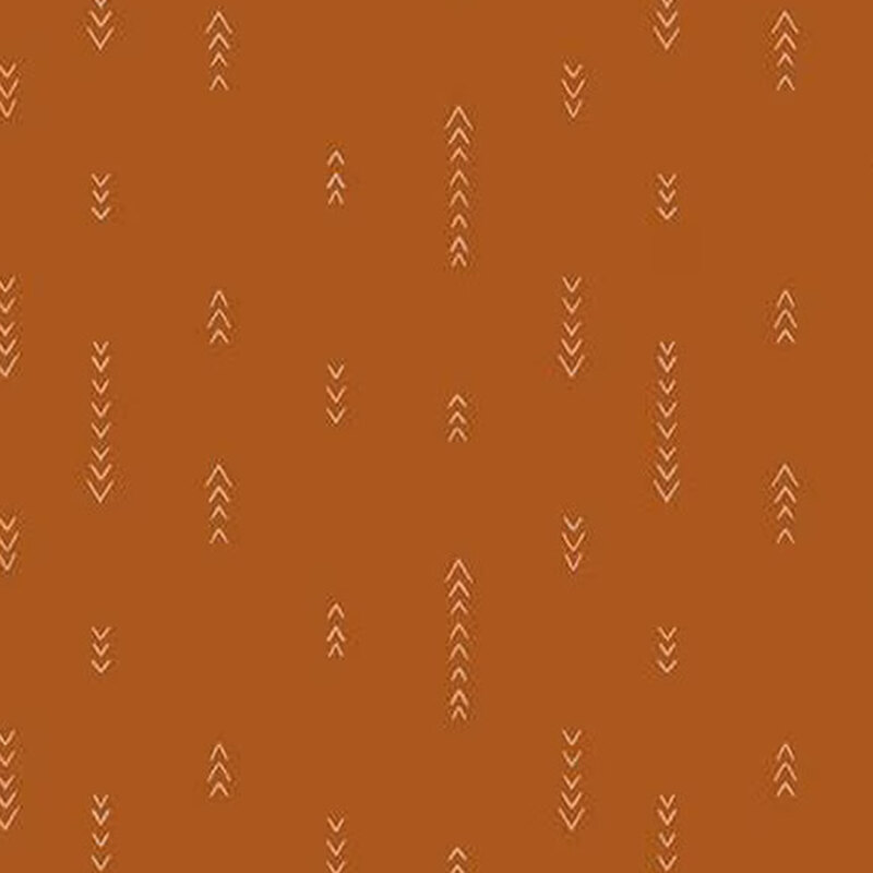 fabric pattern of white arrow motifs on orange background