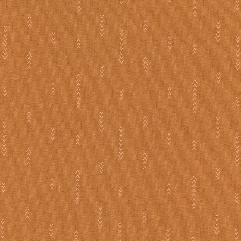 fabric with vertical lines of simplified arrows on a burnt orange background.