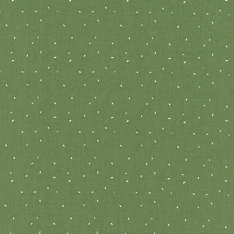 fabric with tiny white flecks on a green background.