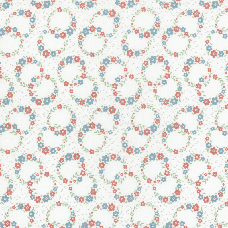 White fabric with a calico pattern of floral wreaths overlapping.
