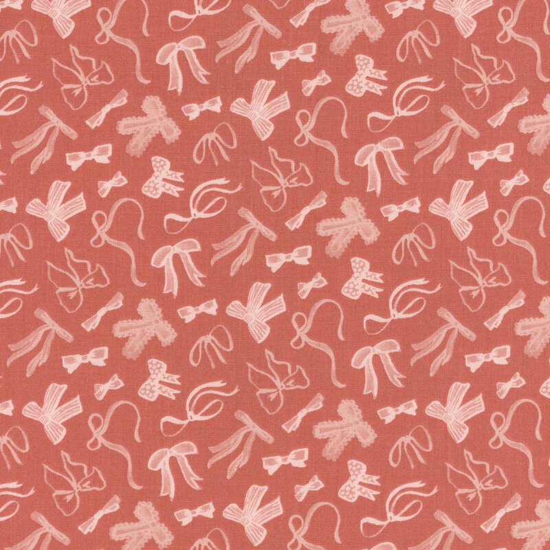 Rusty pink fabric with a pattern of tossed pink bows in various styles.