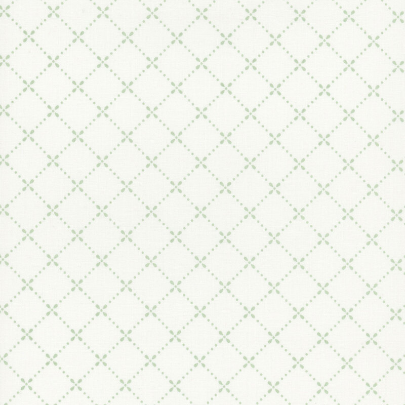 White fabric with a dotted lattice pattern in green.
