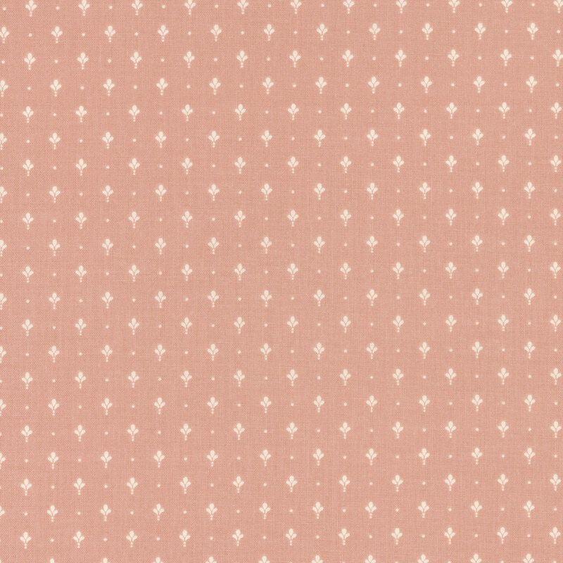 Coral pink fabric with a neat array of simplified light fleur de lis.
