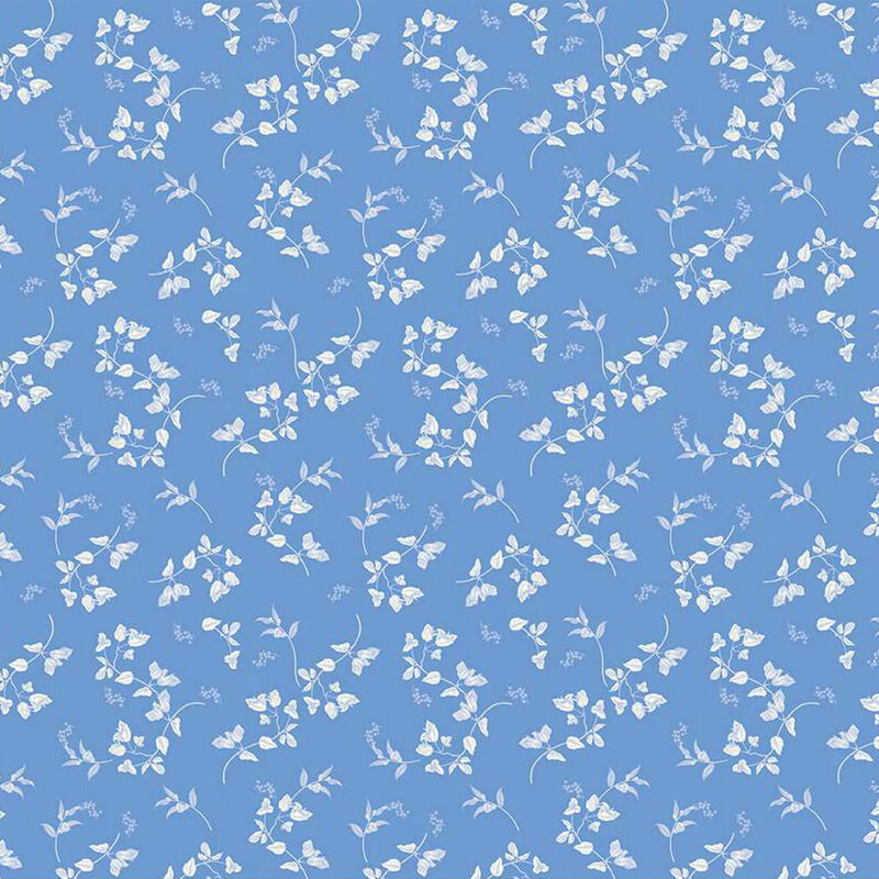 Light blue fabric featuring a scattered pattern of white flowers and leaves.