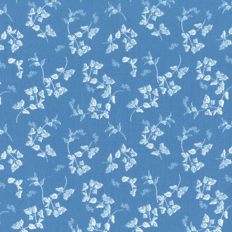A blue fabric with tossed white leaves.