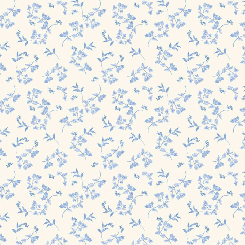 Light cream fabric with a delicate pattern of small blue flowers and green leaves.