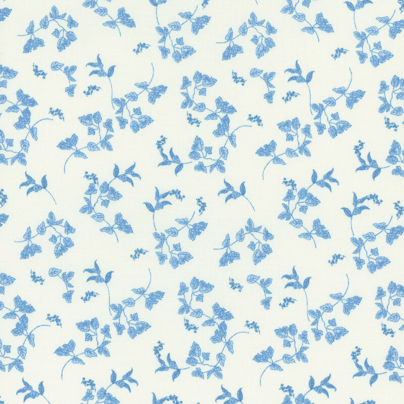 A white fabric with tossed blue leaves.