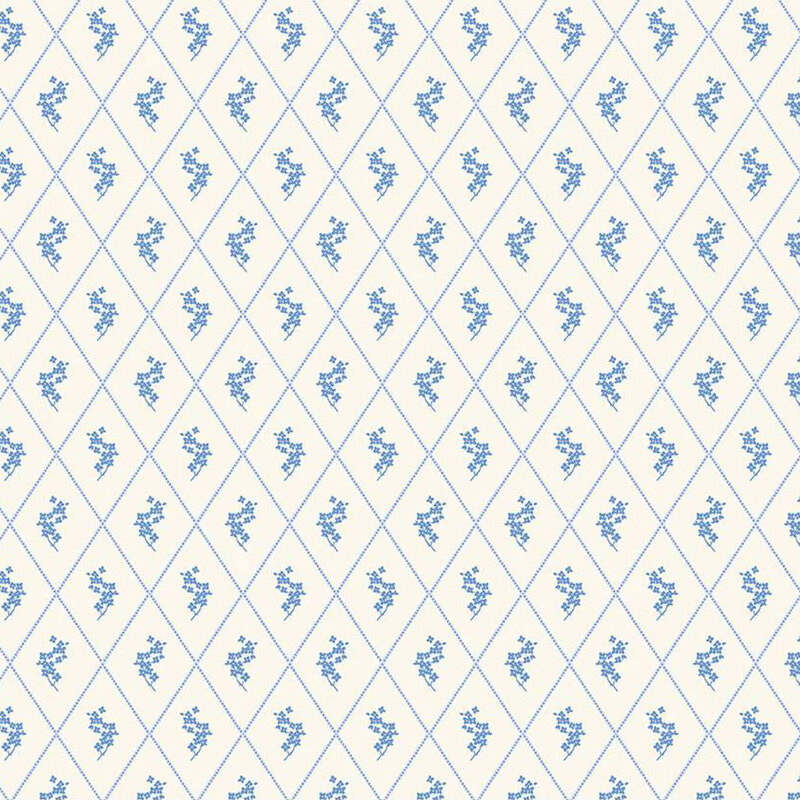 Repeating diamond pattern with light blue floral motifs on a cream fabric.