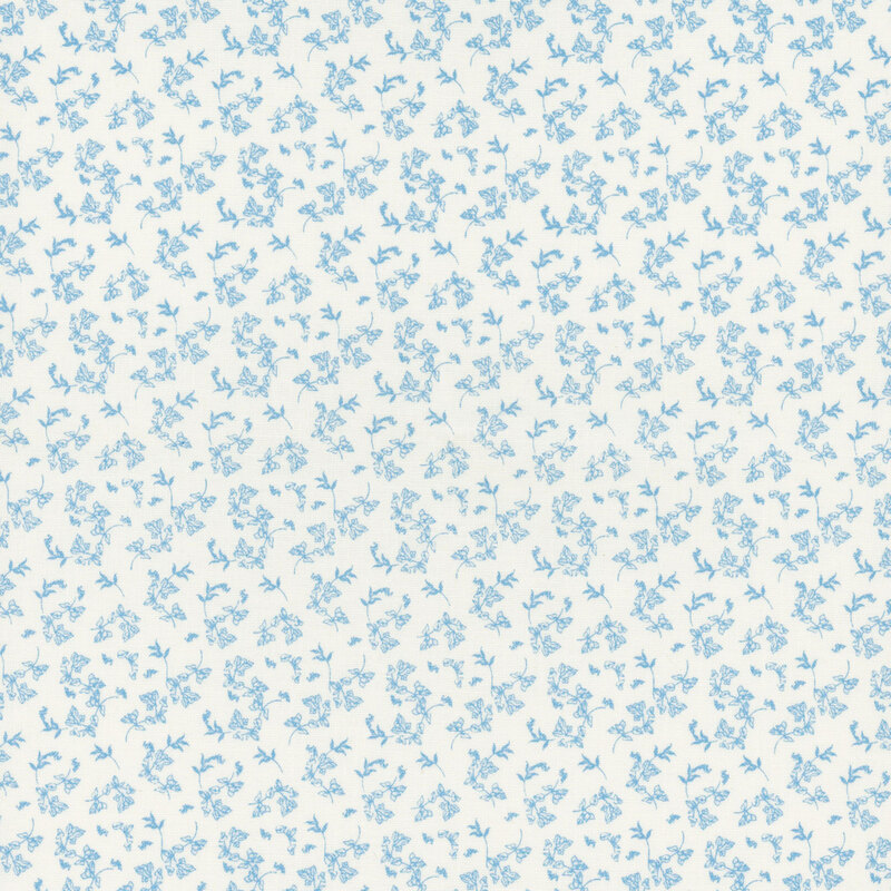 A white fabric with small tossed blue florals.