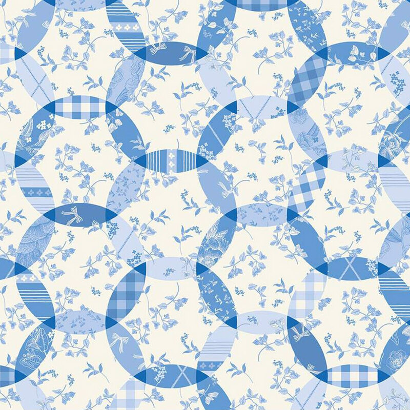 Repeating fabric parrern of interlocking circles in various shades of blue with floral and plaid designs.