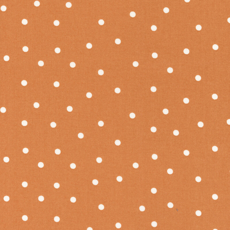 Burnt orange fabric with scattered solid white polka dots.