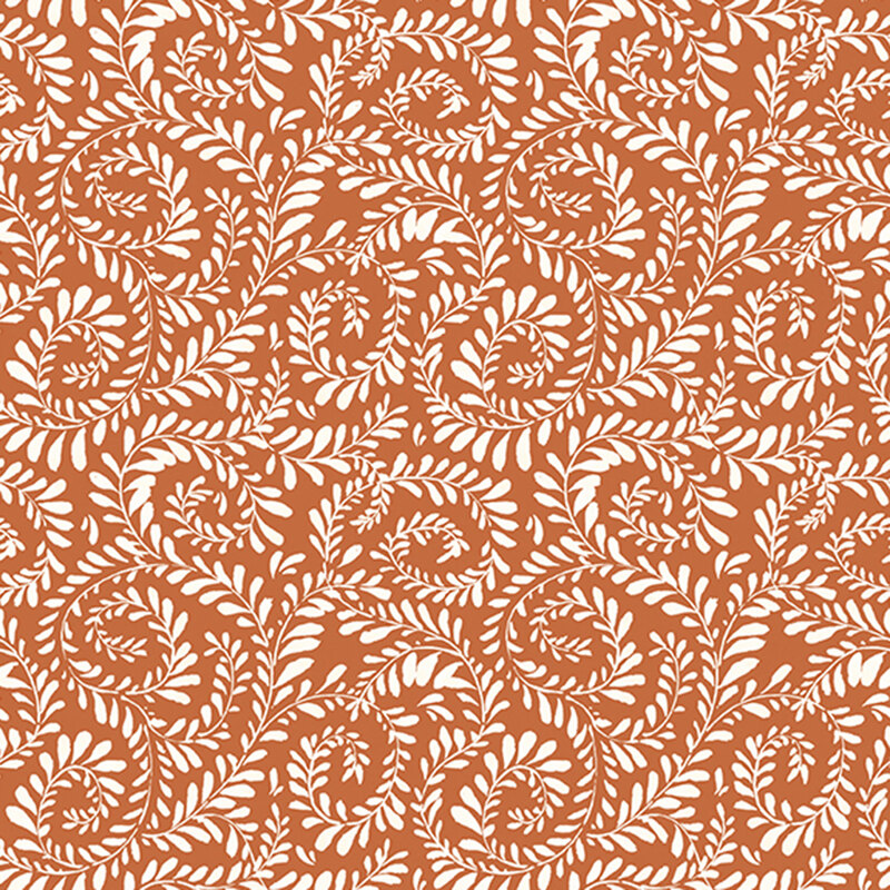 Burnt orange fabric with vines curled in a swirling pattern.