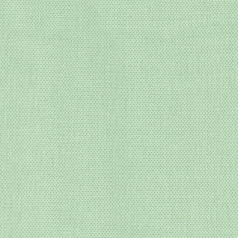 Sage green fabric featuring a dotted halftone tonal print.