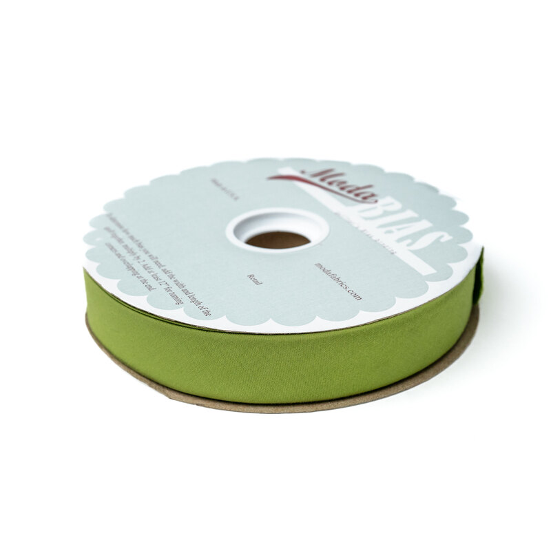 Spool of green bias tape isolated on a white background