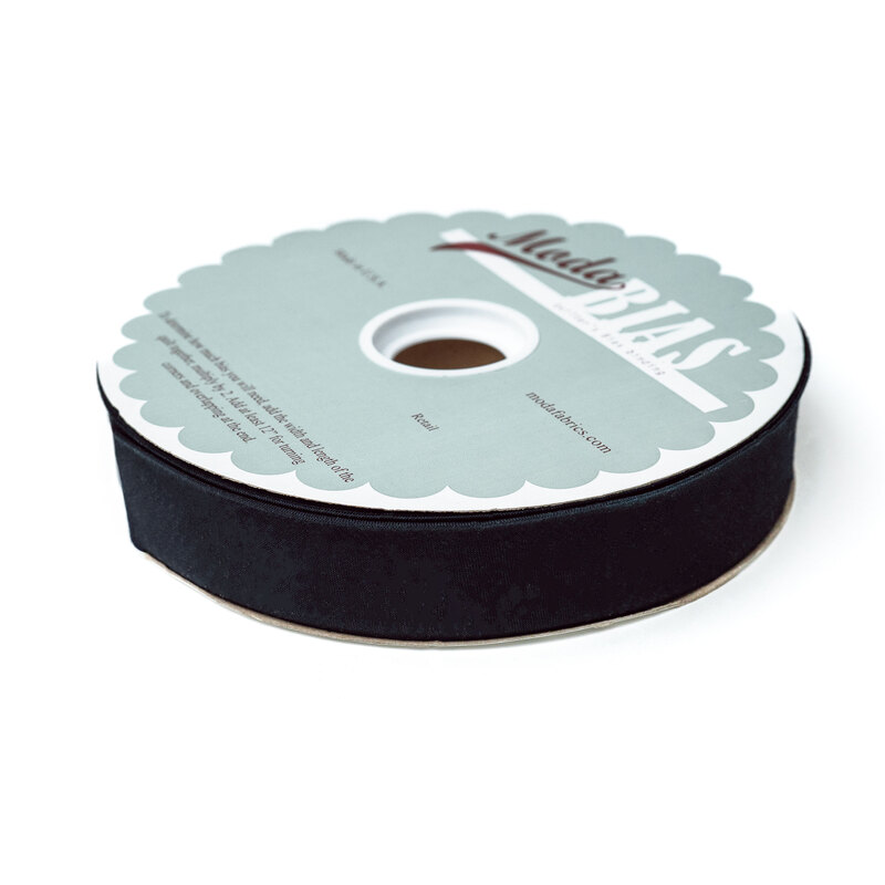 Spool of black bias tape isolated on a white background