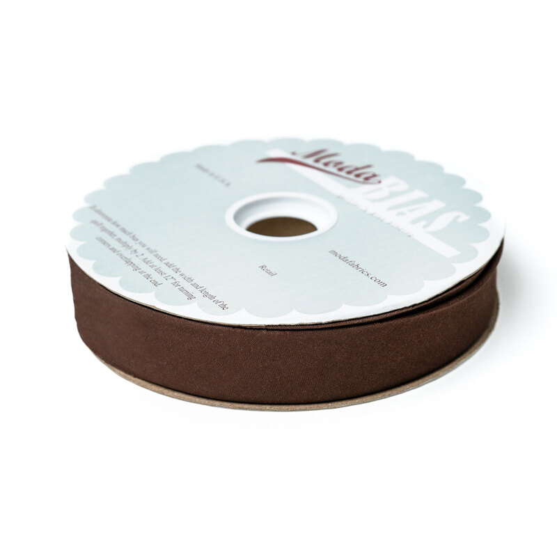 Spool of brown bias tape isolated on a white background