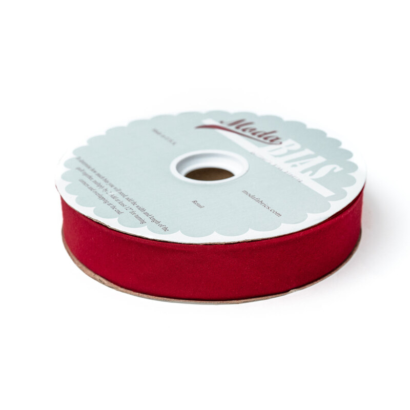 Spool of red bias tape isolated on a white background