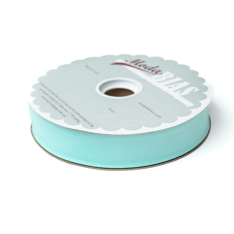 Spool of light aqua bias tape isolated on a white background