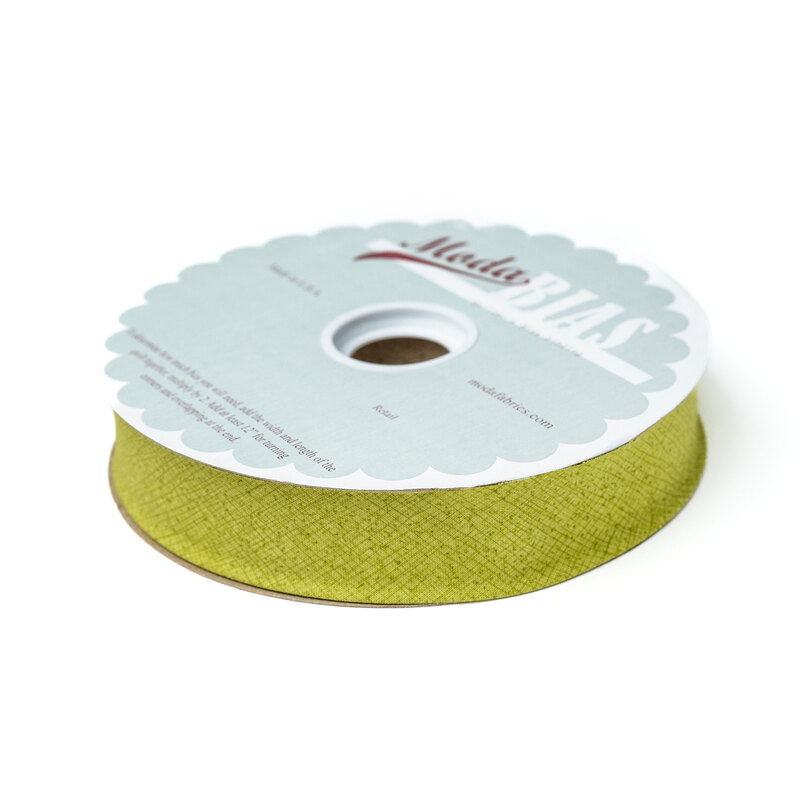 Spool of chartreuse bias tape isolated on a white background