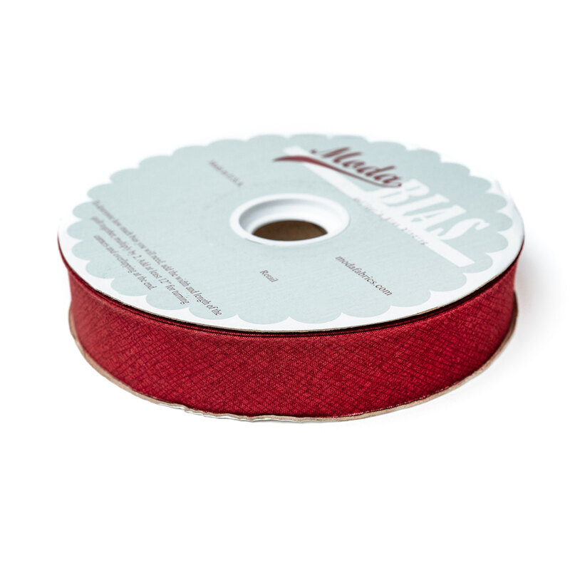 Spool of scarlet red bias tape isolated on a white background