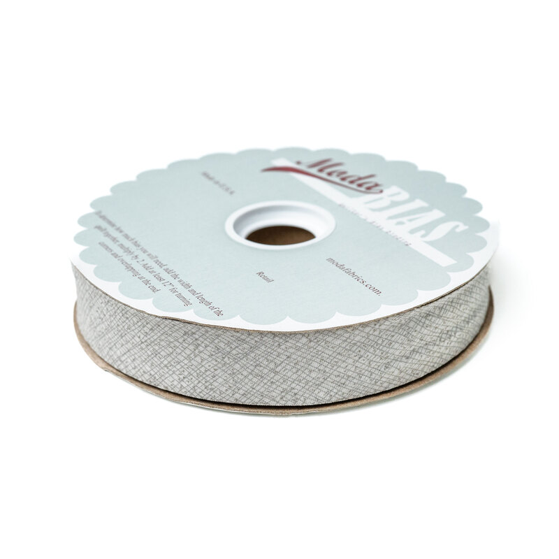 Spool of light gray bias tape isolated on a white background