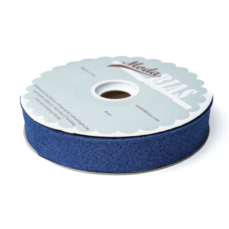 Spool of blue bias tape isolated on a white background