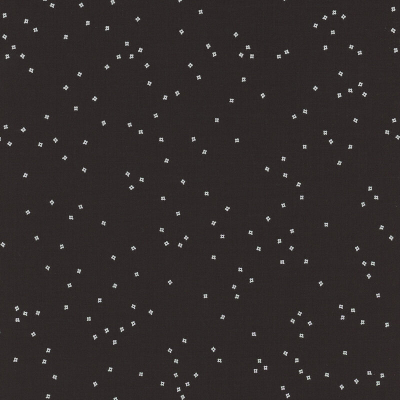 A black fabric with a scattered pattern of small, shiny silver squares.