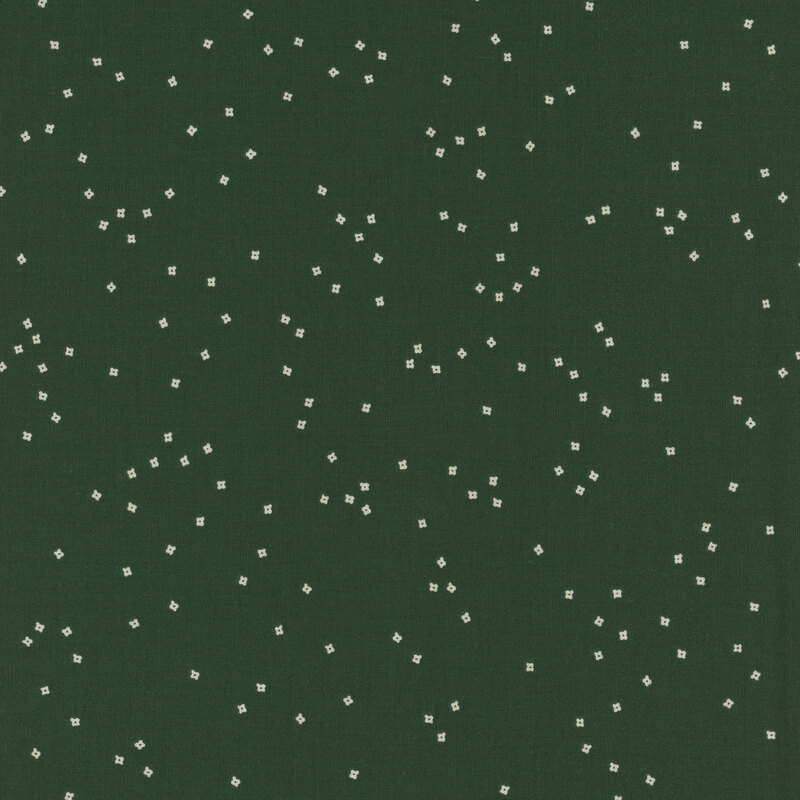 Dark green fabric with scattered white square patterns throughout.