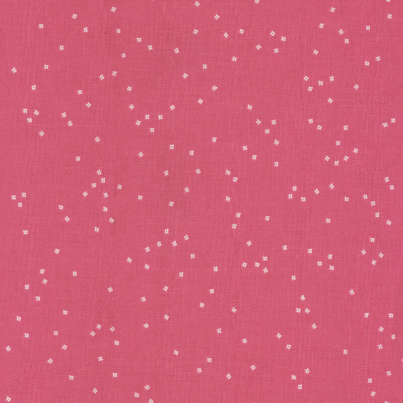 Pink fabric with a subtle pattern of small white squares scattered throughout.