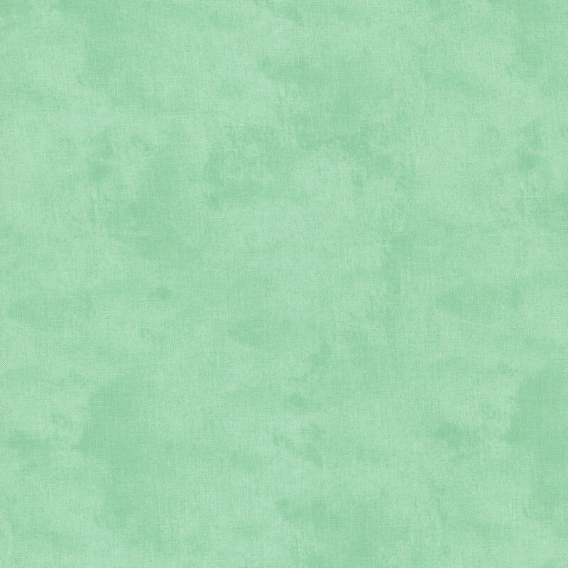 Mottled, textured, and tonal medium jade fabric swatch.