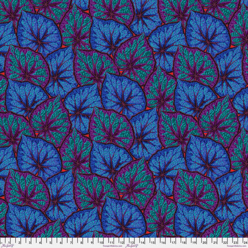 Vibrant blue and purple patterned leaves against a teal background, with a ruler at the bottom.