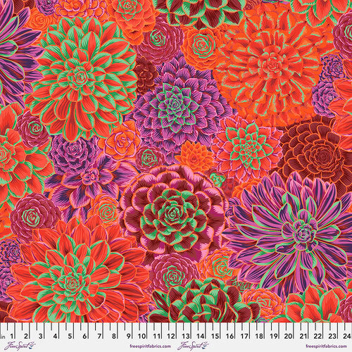 Colorful fabric print featuring various stylized succulents in vibrant reds, purples, and greens.