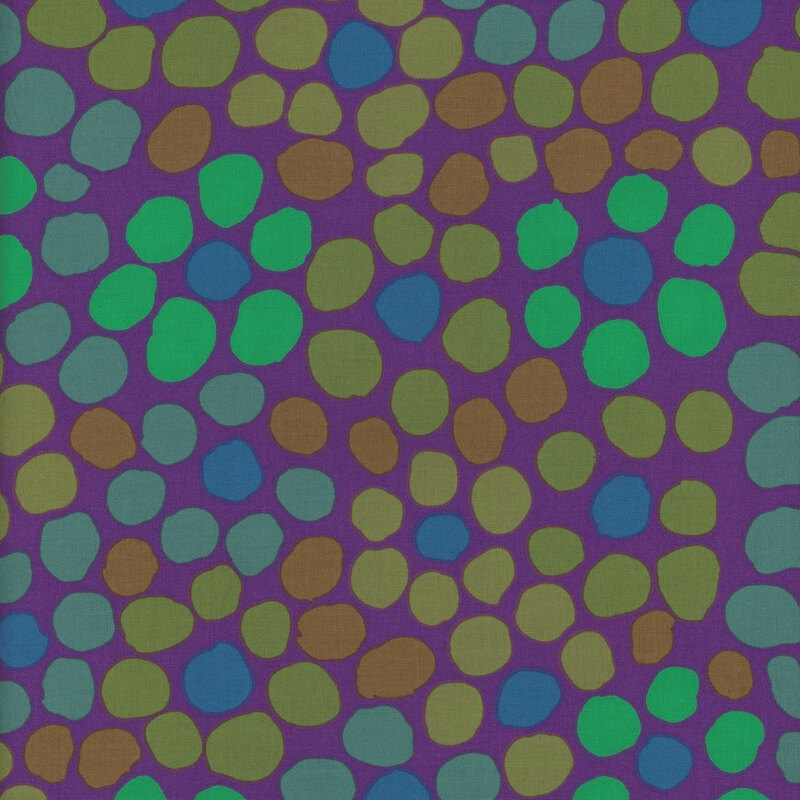 Abstract fabric pattern featuring various-sized green and blue spots on a purple background.