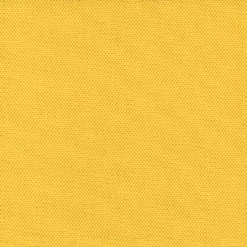 Bright yellow fabric featuring a dotted halftone tonal print.