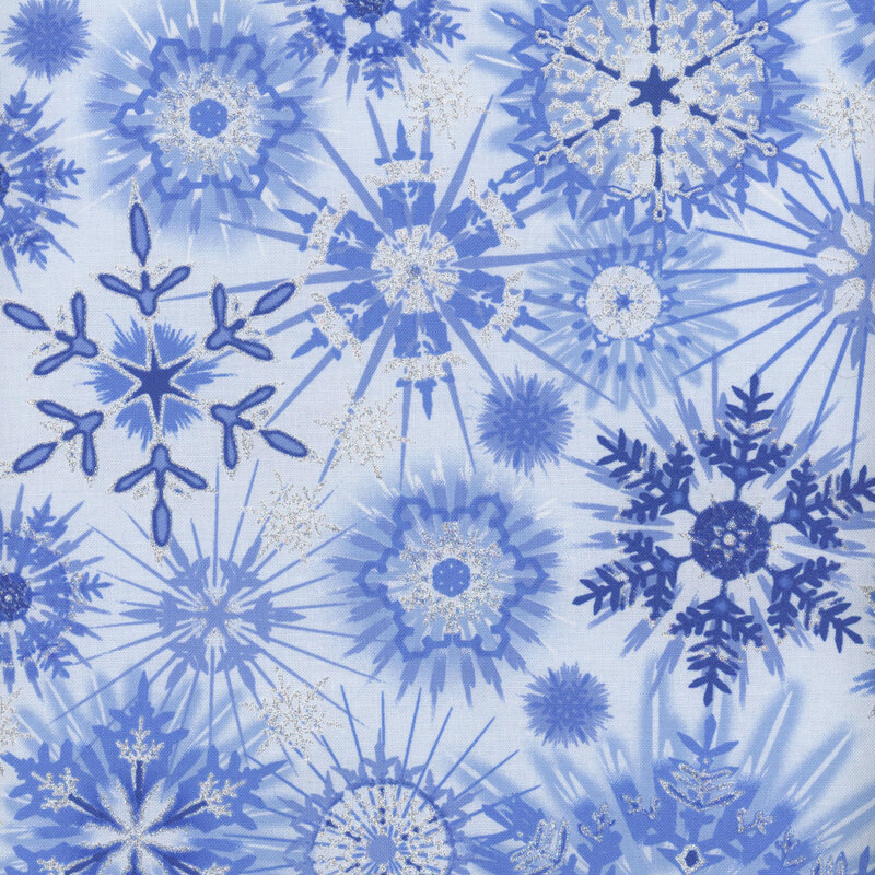 Patterned fabric featuring various blue snowflakes and starbursts on a light blue background.