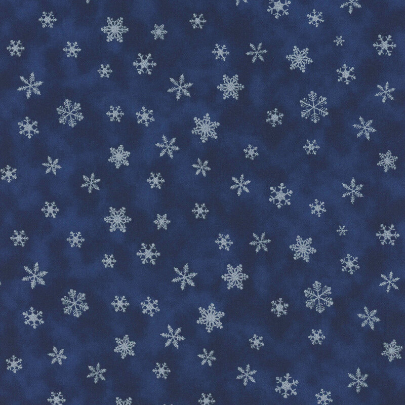 fabric of small white snowflakes on a dark blue background