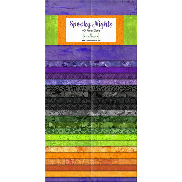 A collection of fabric strips in Halloween colors with various patterns.