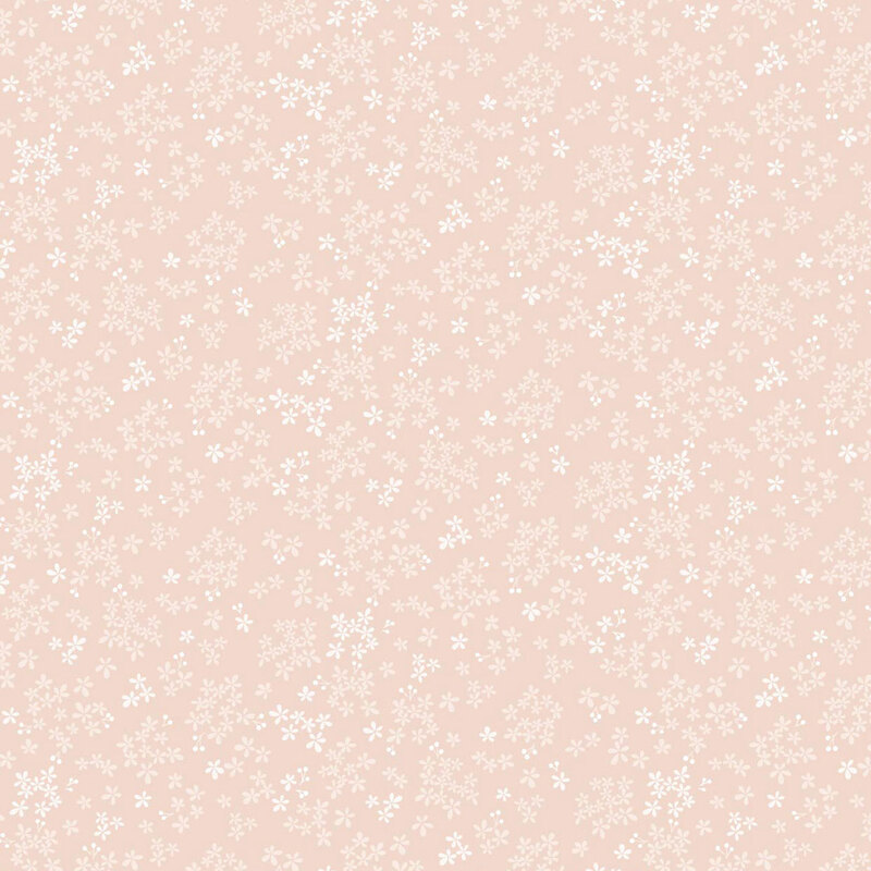 A soft pink fabric adorned with small, scattered white floral patterns.