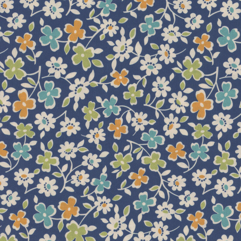 Denim blue fabric with sprawling leaves and colorful flowers.