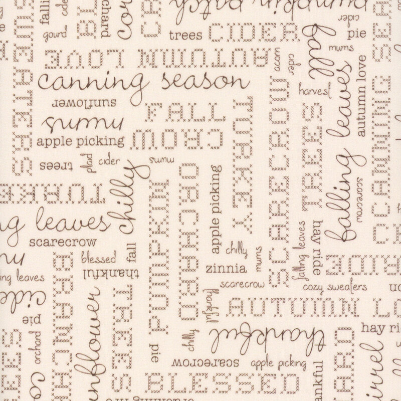 Cream fabric with perpendicular blocks of autumn-themed phrases and words.