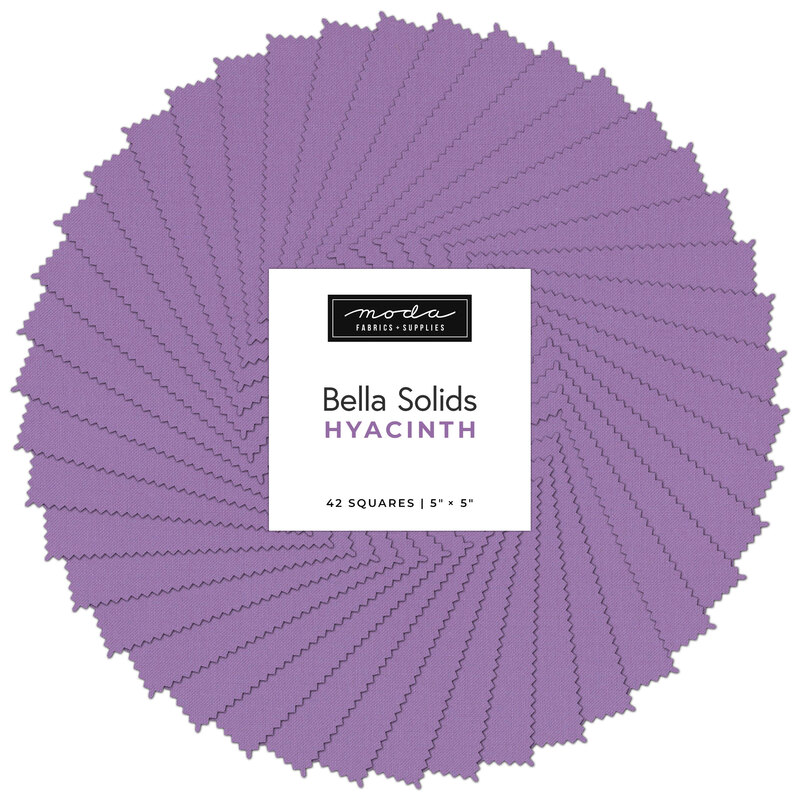 Collage of the solid dusty purple fabrics included in the charm pack, fanned out in a circle.