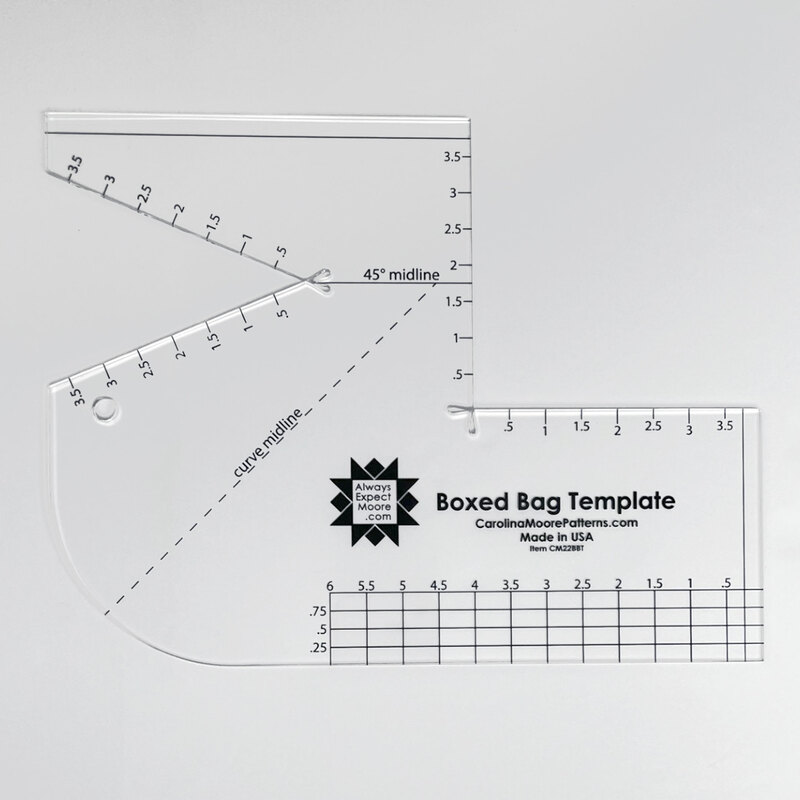 The Boxed Bag Template, an acrylic template with black markings, isolated on a light gray background.