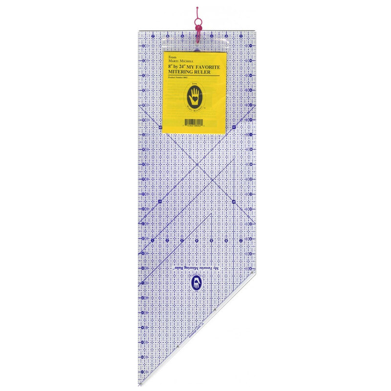 Clear acrylic quilting ruler with grid patterns and angles, featuring a yellow label at the top.