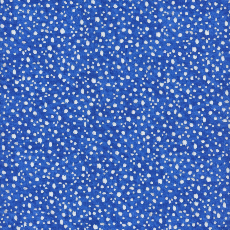 fabric pattern of white dots scattered all over a deep blue marbled background