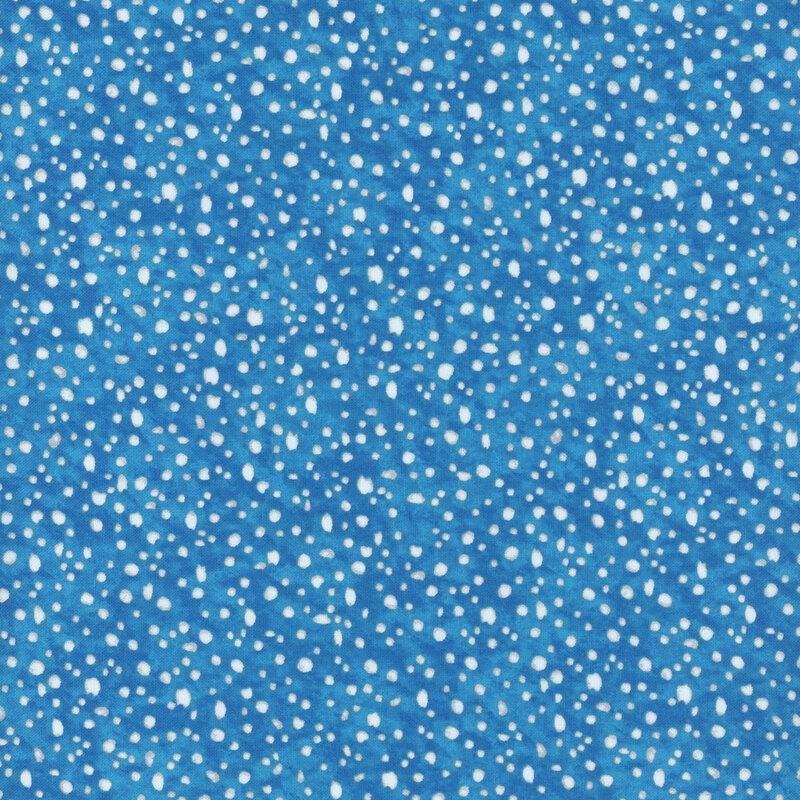 fabric pattern of white dots scattered all over a blue marbled background