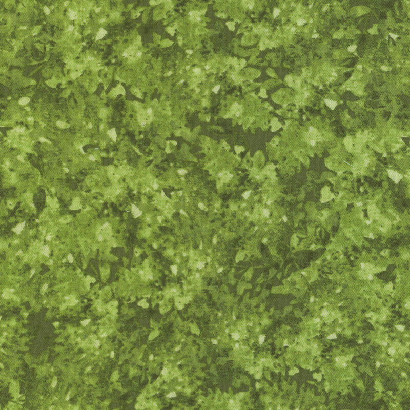 Green fabric with a mottled and flecked design in different shades.